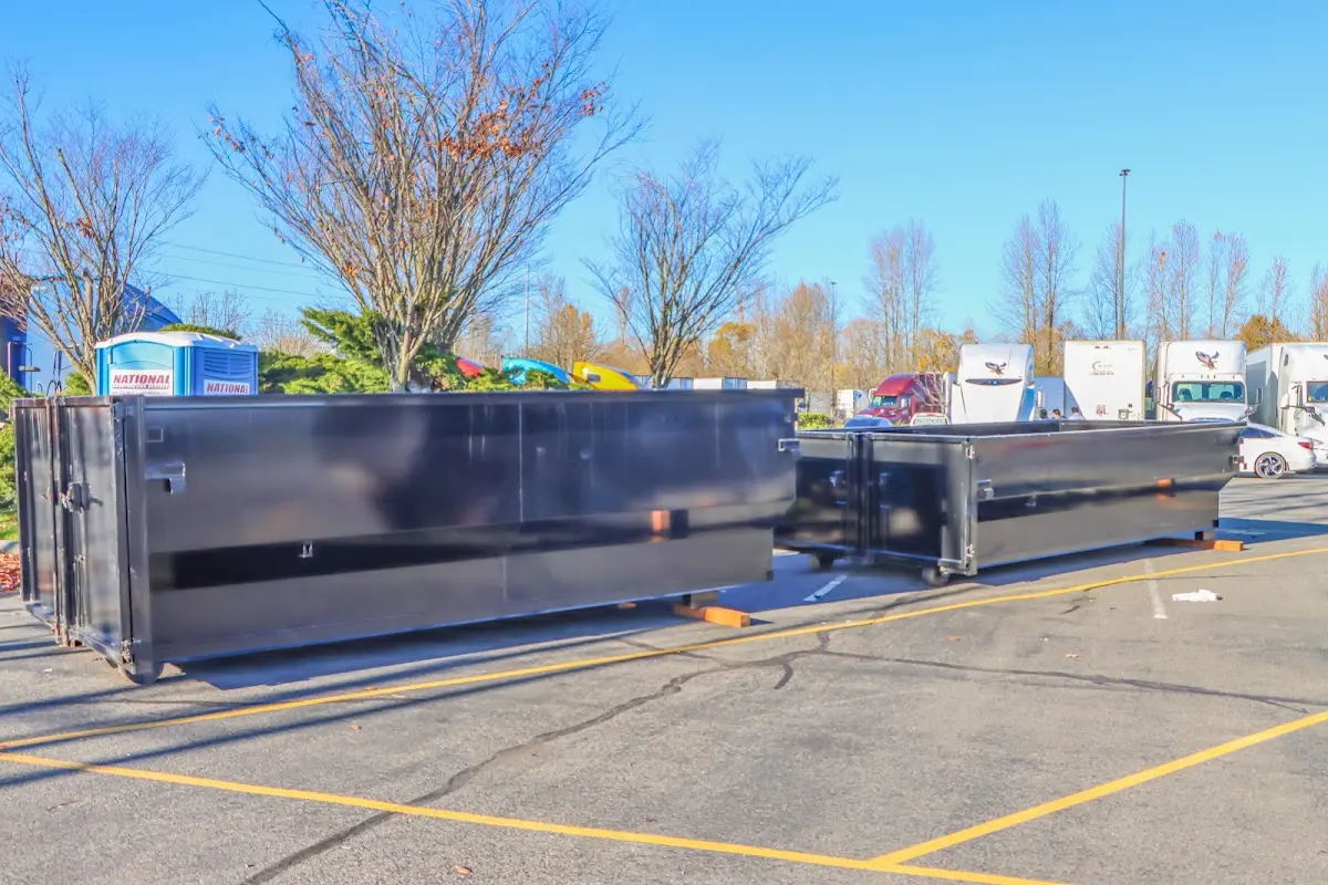 Professional dumpster rental service with roll-off container on residential driveway in Tamarac